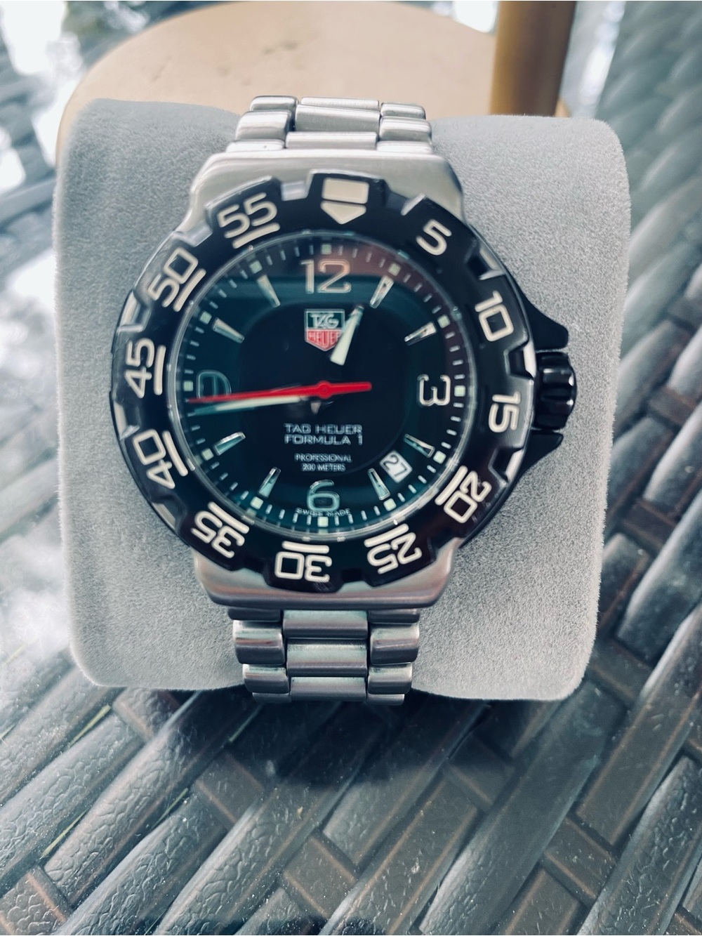 Tag Heuer stainless steel watch with black dial and red seconds hand